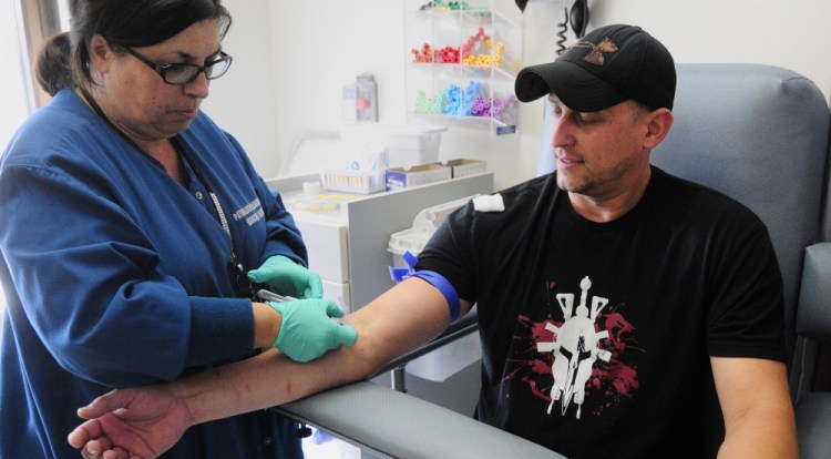 Phlebotomist Del Silva draws blood for tests from veteran Josh Grass at the VA Maine Healthcare System-Togus. Ninety-nine percent of first-time Maine VA patients are getting appointments within 30 days.