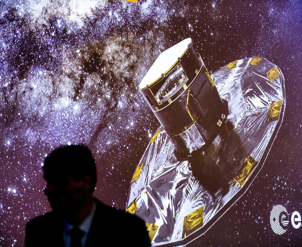 A man walks in front of a slide show depicting the Gaia Mission on Wednesday at the European Space Agency center in Villanueva de la Canada, near Madrid, Spain.