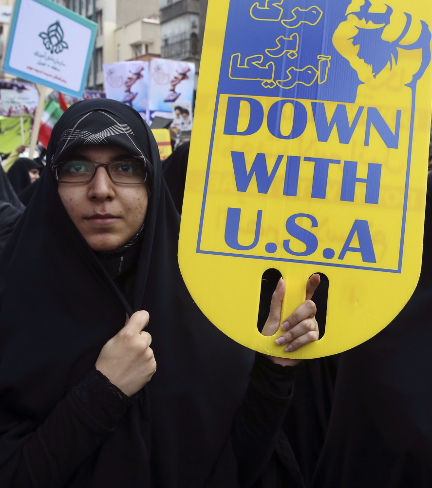 An Iranian demonstrator holds an anti-U.S. placard during an annual rally in front of the former U.S. Embassy in Tehran.