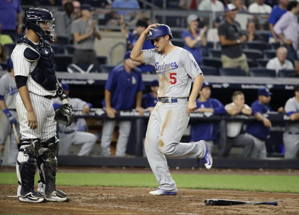The Dodgers' Corey Seager scores in front of Yankees catcher Gary Sanchez during the ninth inning of a 2-0 Los Angeles win at New York on Wednesday.