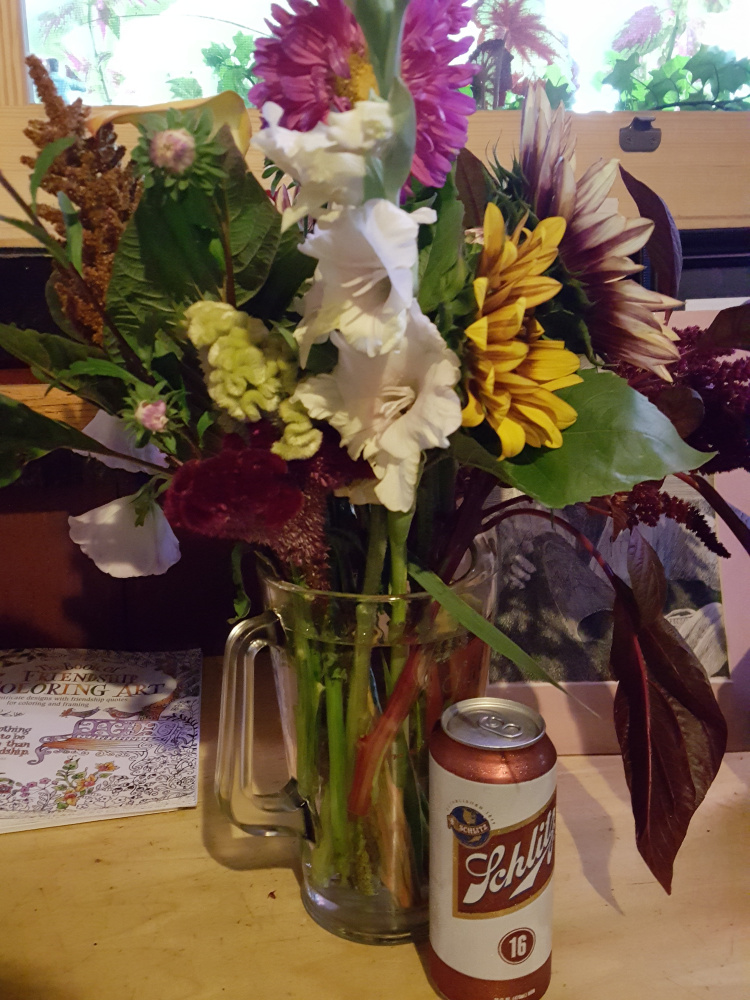 A can of Schlitz sits in front of a vase of flowers at a memorial for Bil Harrison hosted at Ruski's Tavern Wednesday.