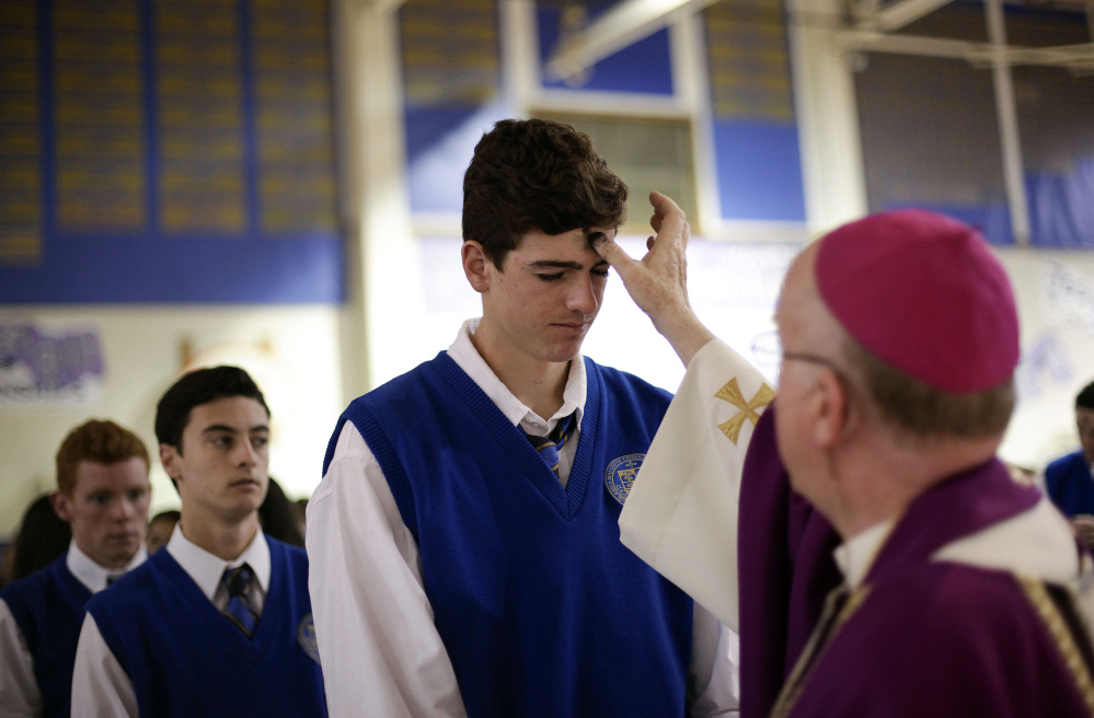 Students line up on Ash Wednesday in 2014 at Santa Margarita Catholic High School in Rancho Santa Margarita, Calif. A new study published this week by a father-daughter researcher team says religion is bigger than Facebook, Google and Apple combined.
