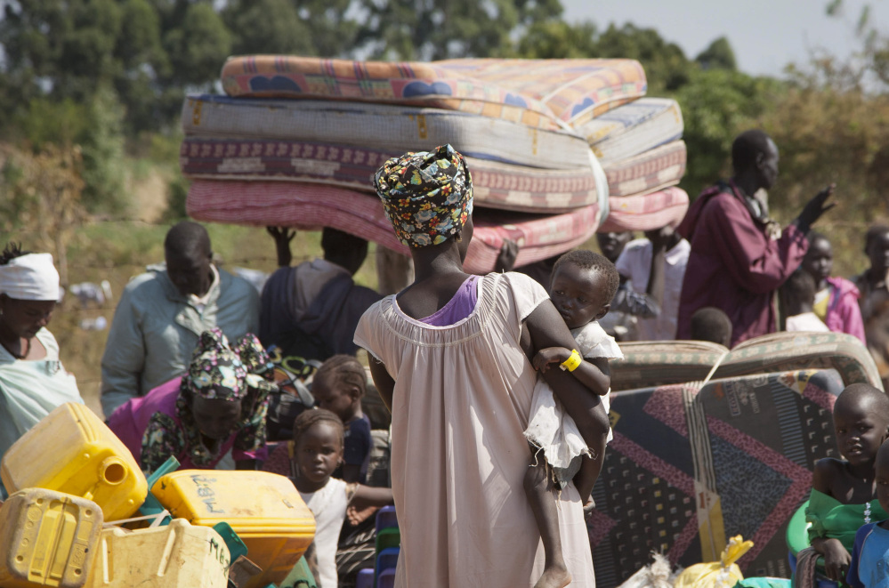 South Sudan refugees await transportation in neighboring Uganda, which hosts the highest number of refugees.