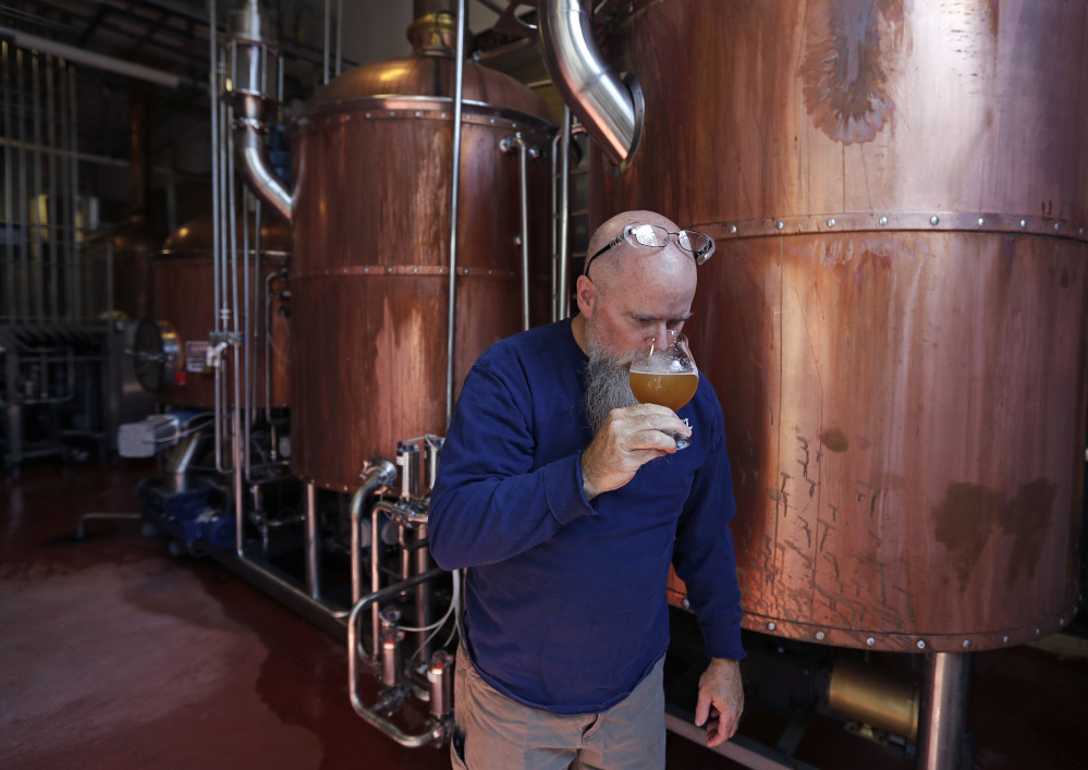 Bob Cannon, a master brewer at Samuel Adams, takes in the aroma of the company's entry in a brewing competition that is the highlight of HUBweek, a Boston-area festival celebrating innovation in art, science and technology.