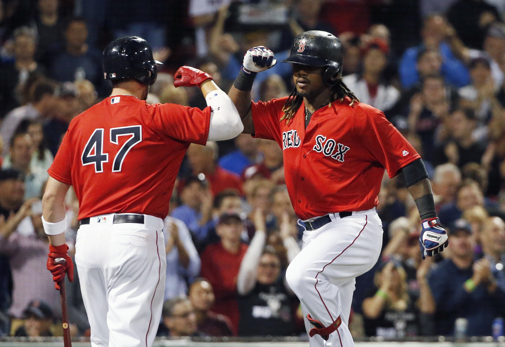 Hanley Ramirez, right, celebrates his home run with Travis Shaw in the fourth inning Friday night at Fenway Park.