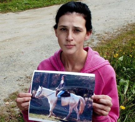 Sierra Miner, 21, shows a photo Thursday of her riding her 4-year-old Appaloosa horse Lucy. "I'm feeling one step closer to actually finding the truth," Miner said.