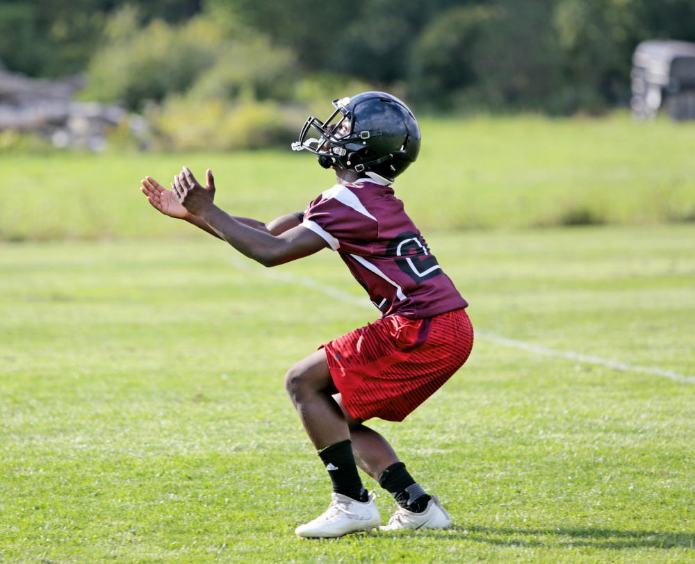 Freshman Naveen Caron gets set to receive a kick during a special-teams drill at Greely High School football practice. Greely joined South Portland and Massabesic in eliminating junior varsity teams this year; Windham and Cheverus dropped their freshman football schedules.