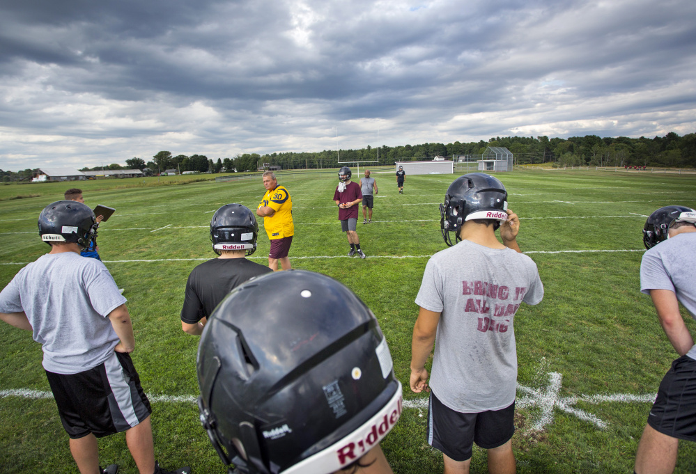 Dave Higgins, head coach of the Greely High School football squad in Cumberland, sets up a special teams drill at a recent practice. Decreasing overall enrollment is the biggest factor behind the decline in football participation in Maine, though others attribute the diminished participation to heightened awareness about the dangers of head injuries.