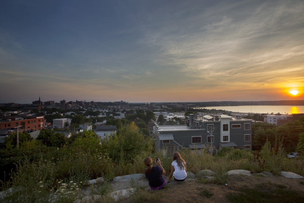 Nicole Hoglund of Portland, left, enjoys the sunset with her niece Sophia Lanzano of New Jersey last August from Fort Sumner Park, a public space on Portland's Munjoy Hill.