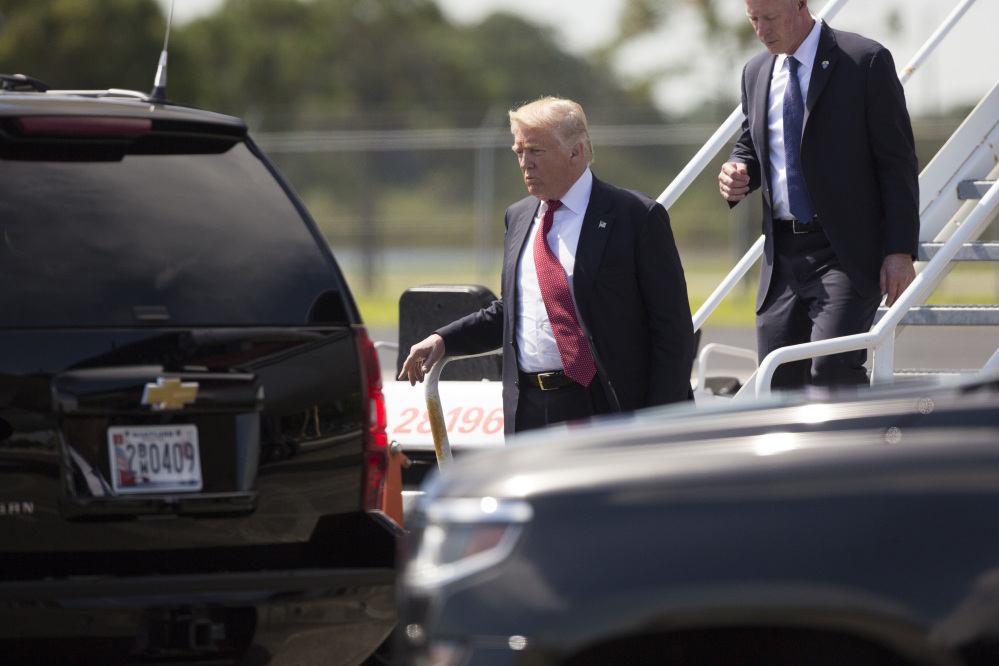 Republican presidential candidate Donald Trump steps off his plane after arriving for a campaign rally at Germain Arena on Monday in Ft. Myers, Fla.