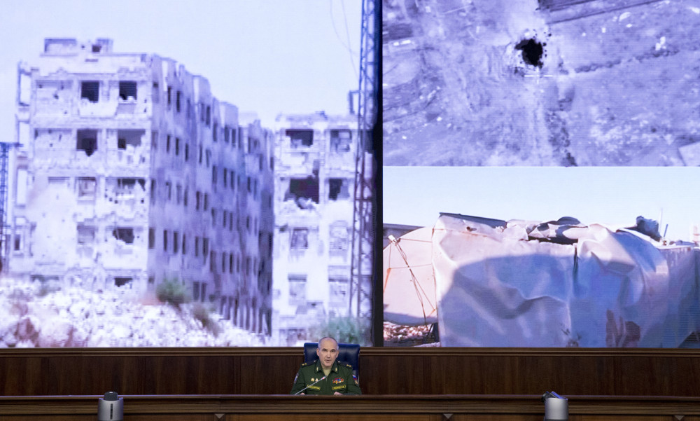 Lt. Gen. Sergei Rudskoi of the Russian military's General Staff speaks to the media in Moscow on Monday about the failure of the cease-fire in Syria, with images of the conflict behind him. He blamed rebel violations for ending the truce.
