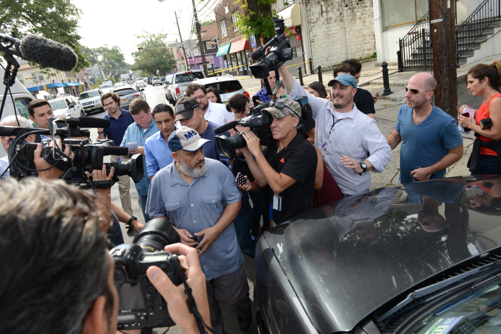The father of Ahmed Rahami, Mohammad Rahami, center left, comes out from his home through a crowd of media to get to his vehicle on Tuesday in Elizabeth, N.J . Mohammad Rahami contacted the FBI two years ago with concerns his son was a terrorist, a law enforcement official said Tuesday. But the father later retracted the claim.