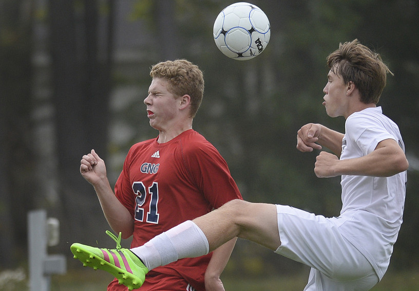 John Martin of Gray-New Gloucester, left, heads the ball away from Shea Wagner of Freeport during Gray-New Gloucester's 1-0 victory Tuesday. The Patriots remained undefeated at 5-0-1.