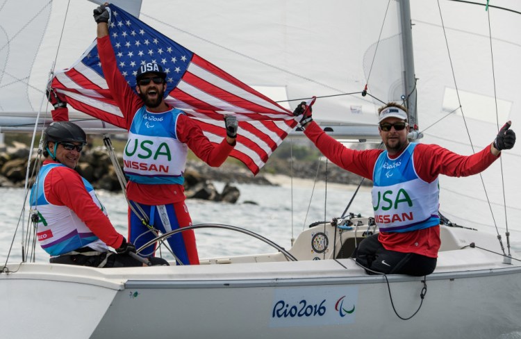 Paralympics silver medalists Hugh Freund of South Freeport, center, with Rick Doerr of New Jersey, left, and Brad Kendell of Florida celebrate in their 23-foot, 3-person keelboat at Marina da Gloria in Rio de Janeiro, Brazil, on Saturday.