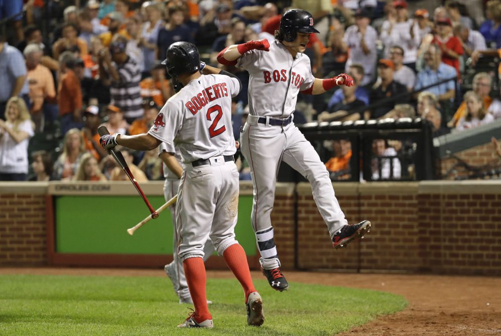 Andrew Benintendi, right, celebrates his three-run home run with teammate Xander Bogaerts in the sixth inning Wednesday night for the Red Sox in Baltimore.
