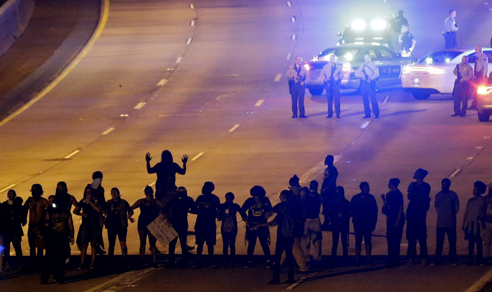Protesters block Interstate 277 in Charlotte on Thursday night, the third night of unrest following Tuesday's police shooting of Keith Lamont Scott. The demonstration halted traffic before officers in riot gear fired pepper balls at the protesters.