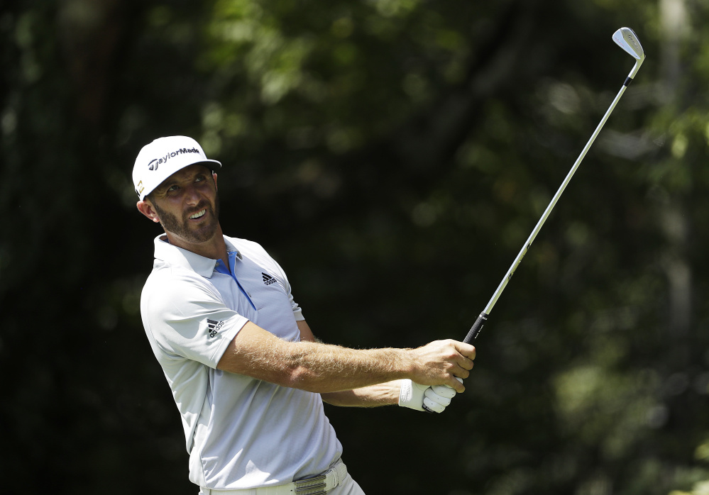 Dustin Johnson tees off on the second hole during the first round of the Tour Championship at East Lake Golf Club on Thursday in Atlanta. Johnson, the FedEx Cup's No. 1 seed, shot 66 for a share of the lead.