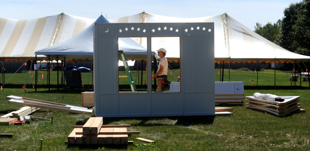 A vendor gets ready Wednesday for the Common Ground Country Fair in Unity, where 60,000 are expected and speakers will address urban farming and producing food locally.