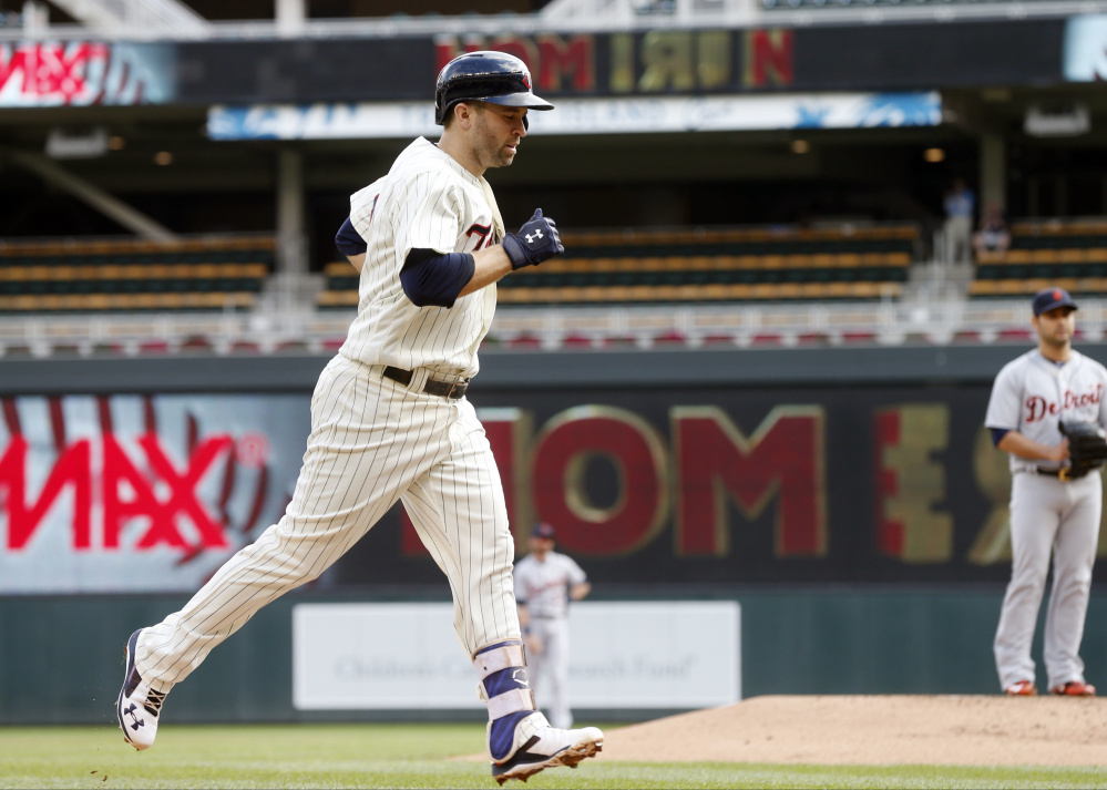 Minnesota's Brian Dozier jogs home after his 42nd home run, a solo shot off Detroit's Anibal Sanchez, right, in the first inning of the Twins' 9-2 loss to the Tigers on Thursday in Minnesota.