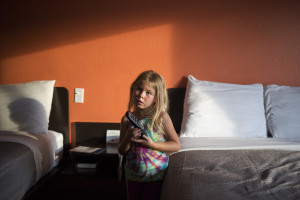 Arianna turns on the TV in a Motel 6 in Lewiston where Joe Dunne, their landlord, put up the family for a night because the apartment wasn't ready to move into.