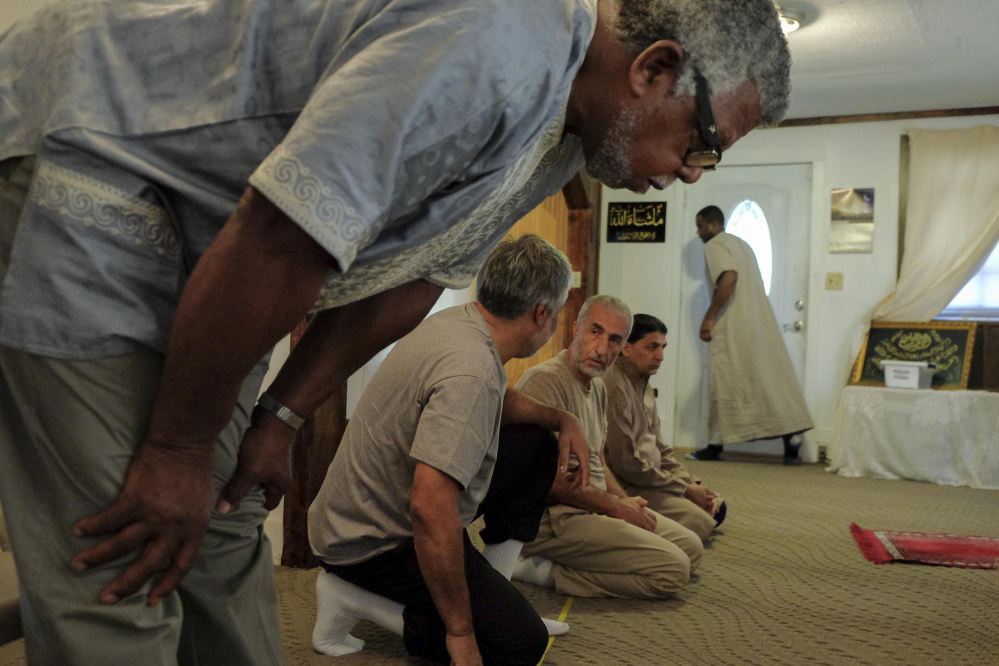 Muslim men prepare to hold Friday afternoon prayers in a temporary worship space in Culpeper, Va. The group has had to put its plans to build a mosque on hold.