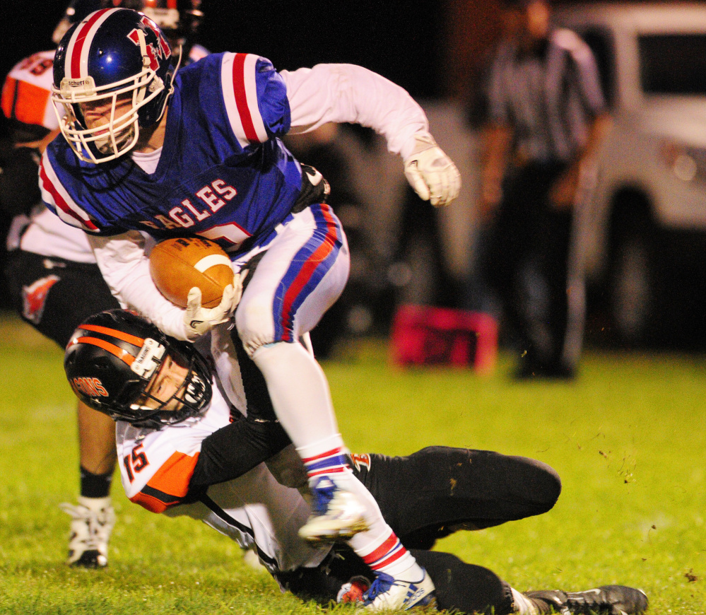 Messalonskee running back Austin Pelletier is tackled by Brunswick defender Aaron Gary during Friday night's game in Oakland. It was tough going for Messalonskee's ball carriers as the Eagles were shut out, 42-0.