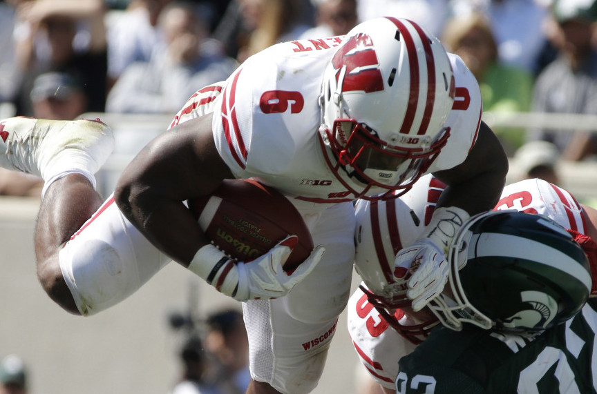 Corey Clement of Wisconsin dives over the line Saturday, scoring one of his two touchdowns that helped the 11th-ranked Badgers humble eighth-ranked Michigan State 30-6 in an early-season Big Ten showdown at East Lansing, Michigan.
