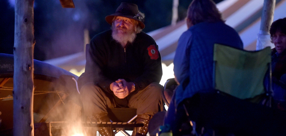 Jeff DeHart, owner of Bear and Otter Guide Services in West Gardiner, sits in his camp at the Common Ground Country Fair.