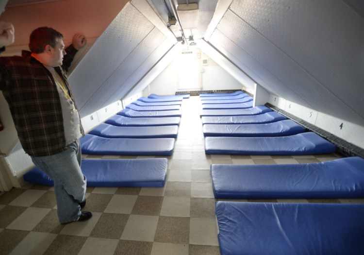 Portland shelter director Robert Parritt checks over a room at the Oxford Street Shelter in 2013. City officials are looking to replace the 31-year-old shelter, which is housed in a former apartment building and converted auto garage in Bayside.