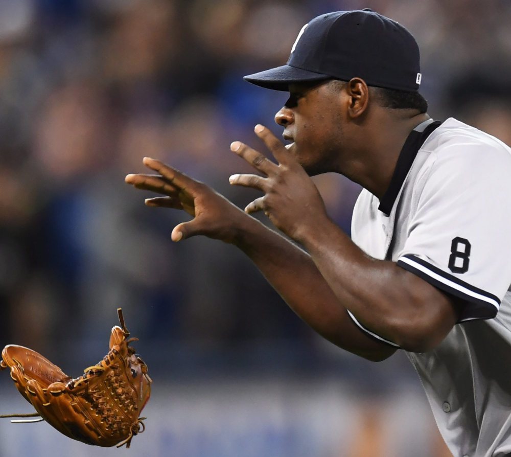 New York pitcher Luis Severino drops his glove as he approaches Toronto's Justin Smoak after hitting him with a pitch and setting off a melee during Monday's game at Toronto.