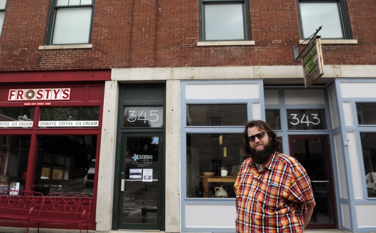 Brad-Lee Nichols stands on Tuesday outside 345 Water St. in Gardiner, where he has opened a co-working space on the second floor. His firm, Starfruit Solutions, which builds websites and apps, provides a professional office to those who need just a bit of space.