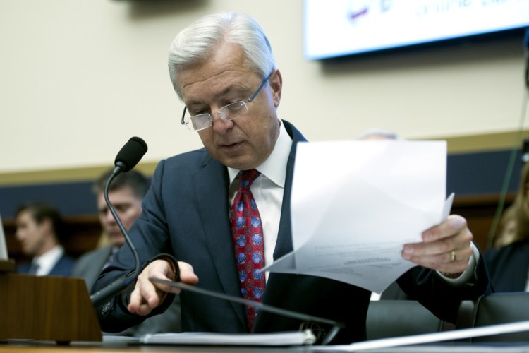 Wells Fargo CEO John Stumpf goes over his notes as he testifies on Capitol Hill in Washington Thursday before the House Financial Services Committee investigating Wells Fargo's opening of unauthorized customer accounts.