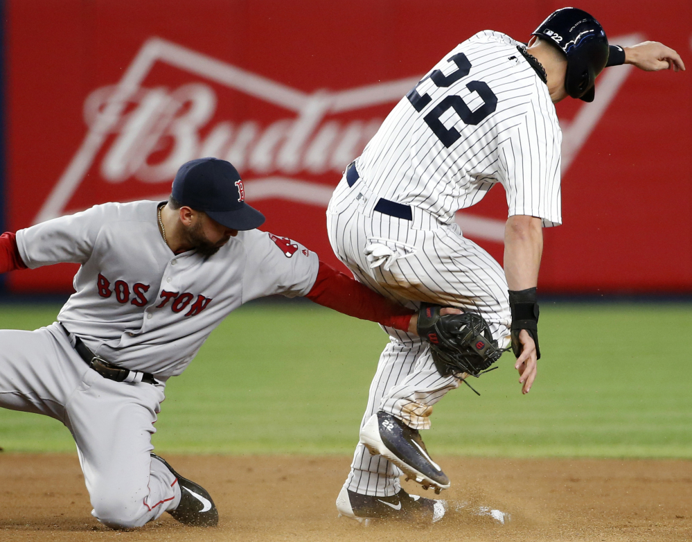 Boston's Deven Marrero applies a late tag on New York's Jacoby Ellsbury, who stole second in the first inning Thursday night in New York.