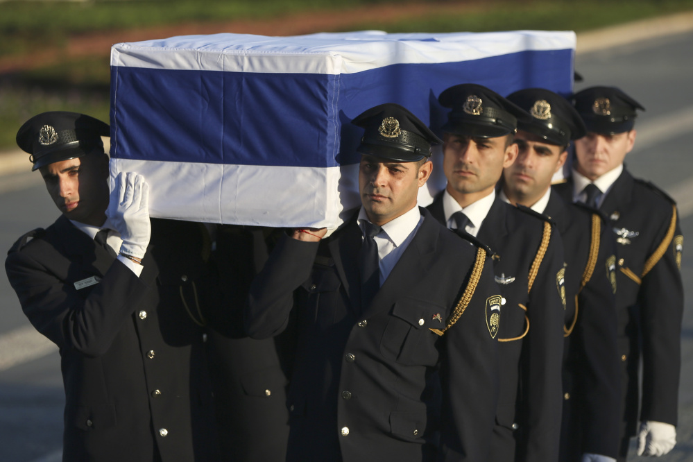 Members of the Knesset guard carry the coffin of former Israeli President Shimon Peres in Jerusalem on Thursday. Peres died early Wednesday from complications from a stroke. He was 93.