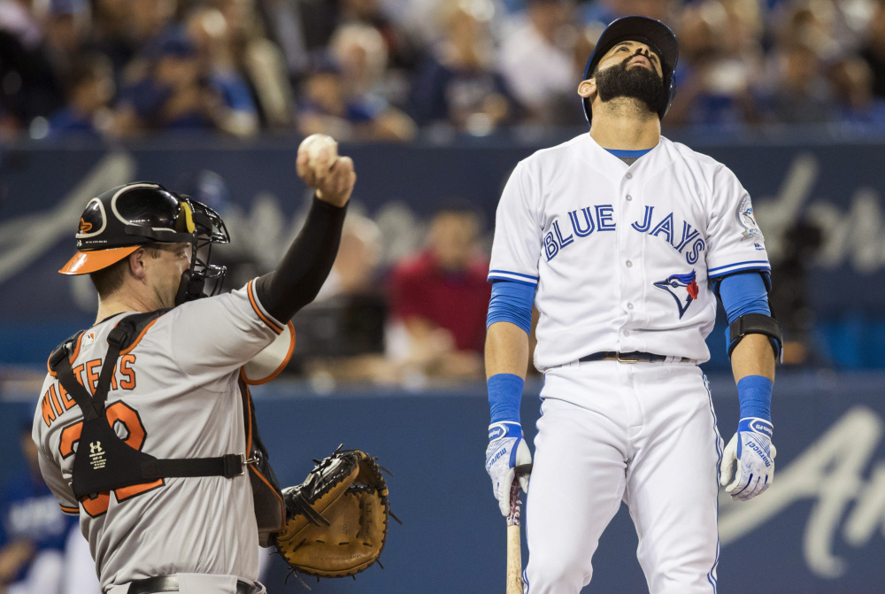 Toronto's Jose Bautista reacts in frustration as Baltimore catcher Matt Wieters tosses the ball back after Bautista struck out during the Blue Jays' 4-0 loss to the Orioles Thursday at Toronto.
