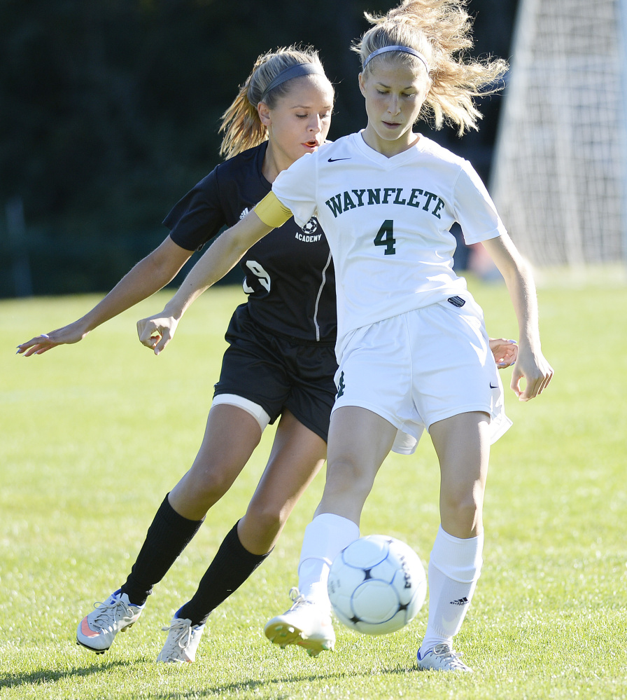 Waynflete's Elisabeth Lualdi tries to keep the ball from Madison Samson of St. Dominic during a girls' soccer game in Portland on Thursday. The Flyers won 3-0. Shawn Patrick Ouellette/Staff Photographer