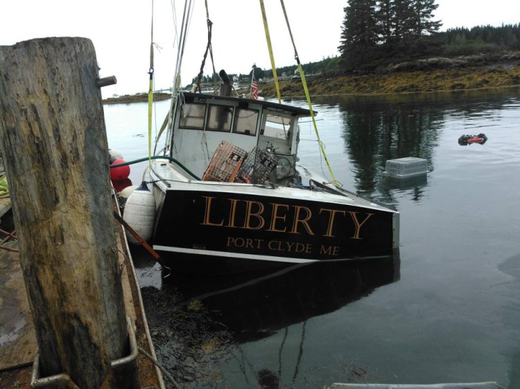 Tony Hooper's lobsterboat is hauled out of the water after it was intentionally sunk on Aug. 17.