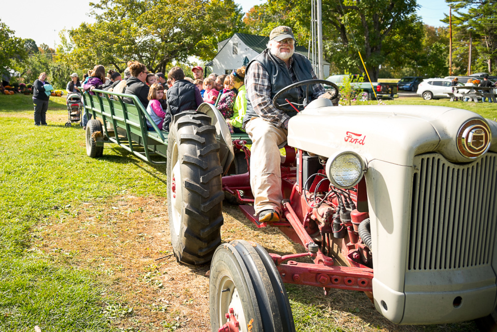 Driver Doug McDougal, of The Apple Farm in Fairfield, begins a hayride taking children and adults around the farm. McDougal pointed out various varieties of apple trees while on the tour.