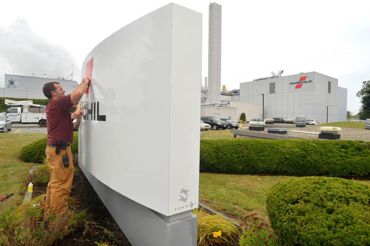 Workers took down the signs for Fairchild Semiconductor in South Portland on Monday after its acquisition by ON Semiconductor. 