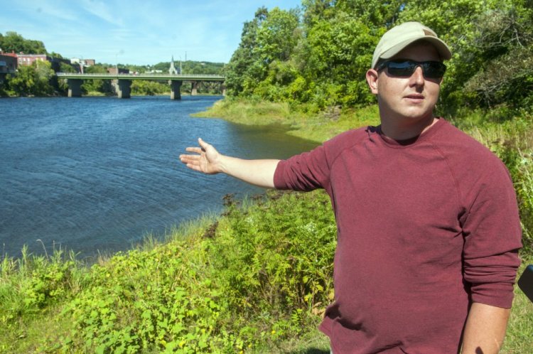 Sean Scanlon of Dresden answers questions Saturday about how he saved a child from drowning in the Kennebec River the evening before at Augusta's East Side Boat Landing. 