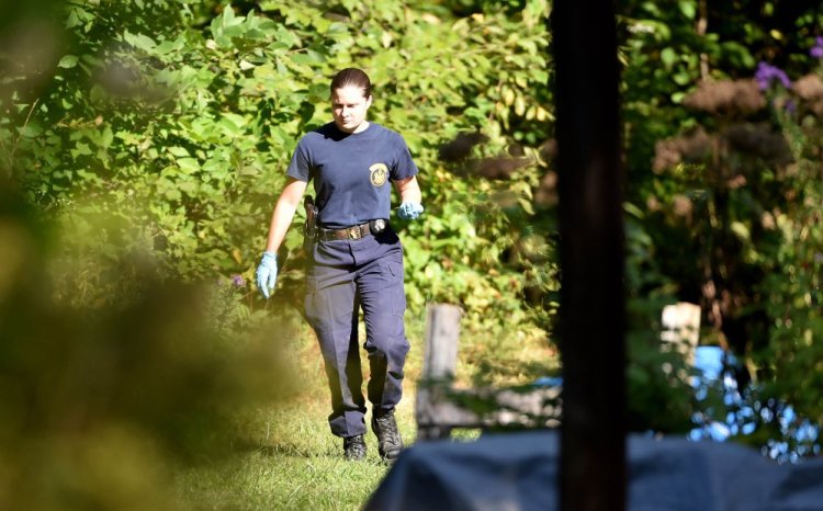 Investigators with the Maine State Police and Maine Warden Service look for evidence in the death of a woman found in the woods behind 628 Norridgewock Road in Fairfield on Tuesday.
Michael G. Seamans/Morning Sentinel