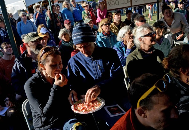 People taste different sample of apples as John Bunker speaks during an apple tasting event at the Common Ground Country Fair in Unity on Saturday. Bunker writes the Fedco Tree catalog and is an expert in apple identification. <em>Michael G. Seamans/Morning Sentinel</em>