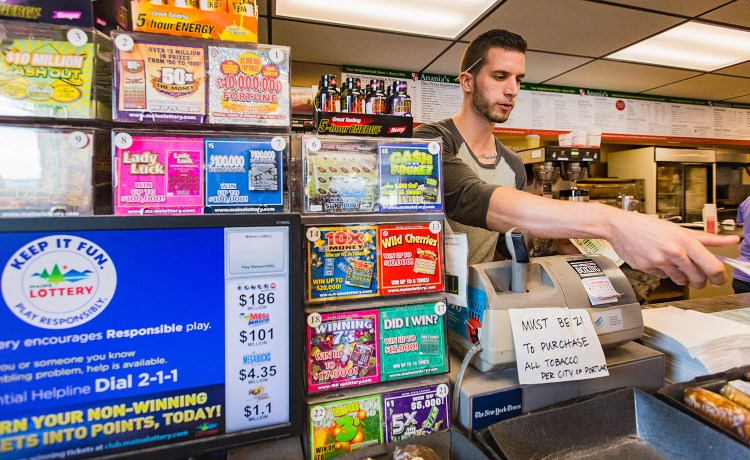 Brett Robertshaw sells a scratch lottery ticket at Anania's in Portland on Sunday. The Maine Lottery had the biggest success in its 42-year history during the 2016 fiscal year, hitting record highs for ticket sales, prizes paid to winners, commissions earned by retailers and contributions to Maine’s General Fund. A total of $57 million in lottery proceeds went into the fund, up from $54 million in fiscal year 2015.