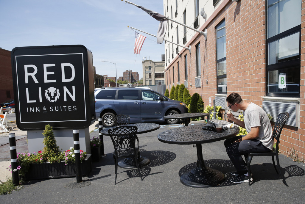 Gary Cornish eats his habitual breakfast, a sandwich and an iced coffee from the corner deli, in the parking lot of the Red Lion Inn & Suites in New York where he and the other members of his team stay when the team is not traveling. Associated Press/Kathy Willens