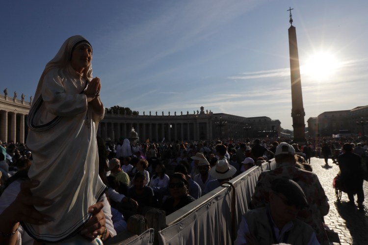 Irma Escuero of New York holds a statue of Mother Teresa before her canonization Mass in St. Peter's Square at the Vatican on Sunday. 
Associated Press/Gregorio Borgia