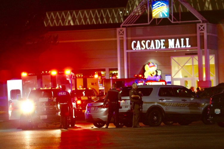 Police officers work at the crime scene outside the Cascade Mall in Burlington, Wash., where several people were fatally shot on Friday. (Dean Rutz/The Seattle Times via AP)