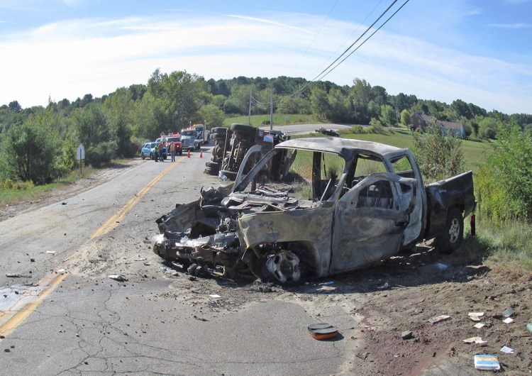 The pickup caught fire after colliding with the dump truck and passers-by pulled three men from the burning truck. Two of the occupants died and one is in critical condition. <em>Photo courtesy of the Maine Department of Public Safety</em>