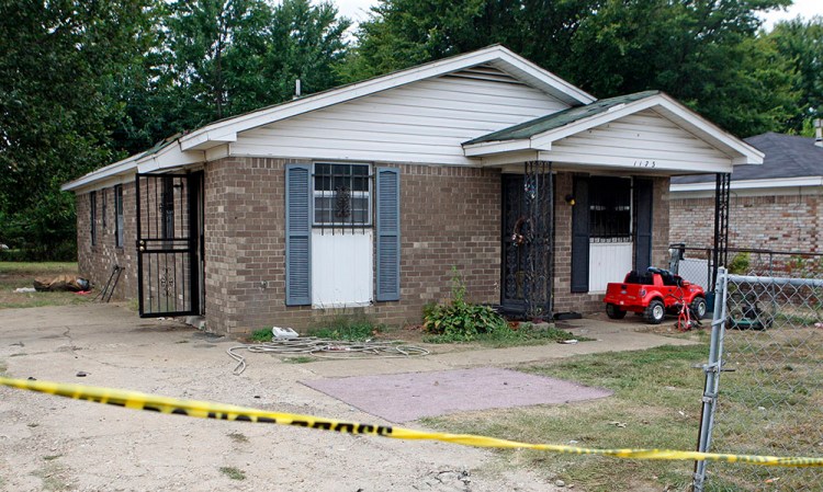 Security tape stretches across the driveway of a home where an early morning fire killed nine people Monday in Memphis, Tenn. <em>Associated Press/Karen Pulfer Focht</em>
