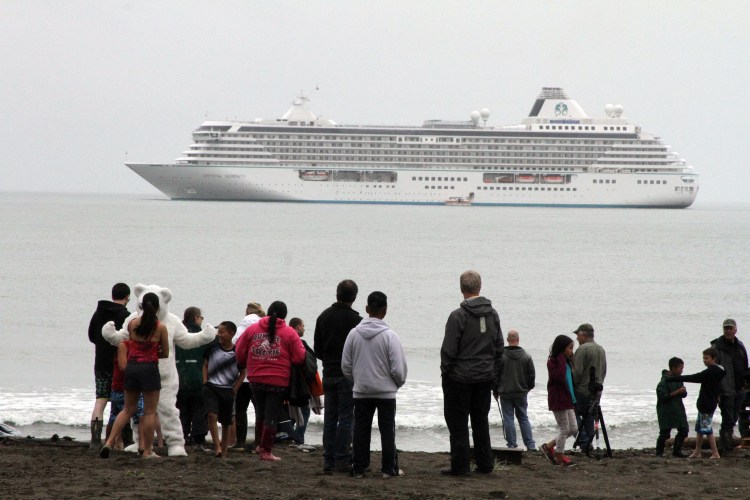 People prepare to take a polar plunge in the Bering Sea as the luxury cruise ship Crystal Serenity lies anchored offshore in Nome, Alaska, on Aug. 21. <em>Mark Thiessen/Associated Press</em>