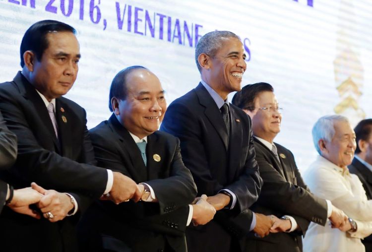 President Obama does an ASEAN-style handshake before the start of the 4th ASEAN-U.S. Summit Meeting at National Convention Center in Vientiane, Laos, Thursday. From left: Thailand's Prime Minister Prayuth Chan-ocha, Vietnam's Prime Minister Nguyen Xuan Phuc, Obama, Laos' Prime Minister Thongloun Sisoulith, and Philippines Foreign Affairs Secretary Perfecto Yasay. <em>Carolyn Kaster/Associated Press</em>